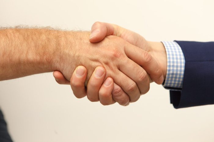 A photograph of shaking hand.